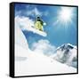 Snowboarder at Jump Inhigh Mountains at Sunny Day.-IM_photo-Framed Stretched Canvas