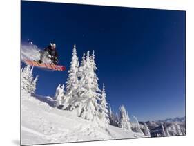 Snowboarding Action at Whitefish Mountain Resort in Whitefish, Montana, USA-Chuck Haney-Mounted Photographic Print