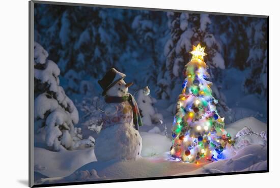 Snowman Standing In A Snow-Covered Spruce Forest Next To A Decorated Christmas Tree In Wintertime-Design Pics-Mounted Photographic Print