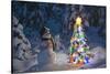 Snowman Standing In A Snow-Covered Spruce Forest Next To A Decorated Christmas Tree In Wintertime-Design Pics-Stretched Canvas