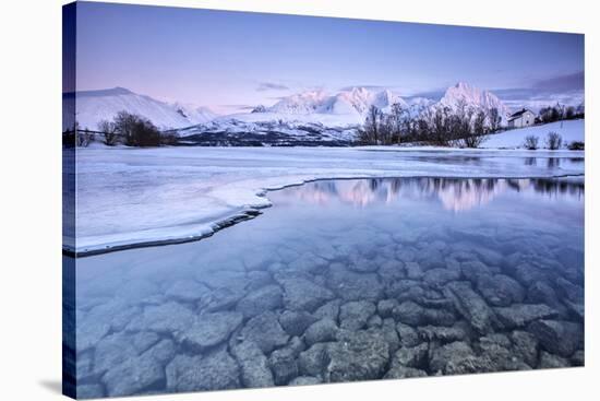 Snowy peaks are reflected in the frozen Lake Jaegervatnet at sunset Stortind Lyngen Alps Tromsa? La-ClickAlps-Stretched Canvas