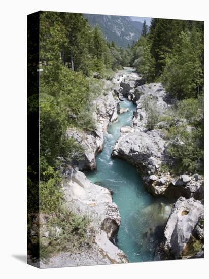 Soca River with Clear Emerald Water Flowing Between Eroded Rocks in Trenta Valley in Summer-Pearl Bucknall-Stretched Canvas
