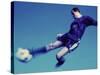 Soccer Player Jumping in Mid Air to Kick a Soccer Ball-null-Stretched Canvas