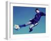 Soccer Player Jumping in Mid Air to Kick a Soccer Ball-null-Framed Premium Photographic Print