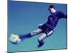 Soccer Player Jumping in Mid Air to Kick a Soccer Ball-null-Mounted Premium Photographic Print