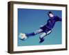 Soccer Player Jumping in Mid Air to Kick a Soccer Ball-null-Framed Photographic Print