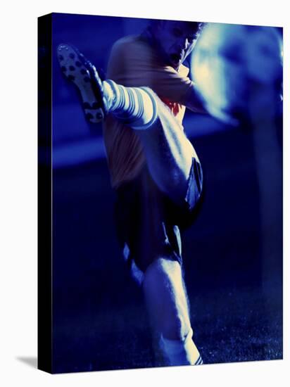 Soccer Player Kicking a Soccer Ball-null-Stretched Canvas