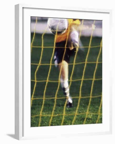 Soccer Player Kicking a Soccer Ball-null-Framed Photographic Print