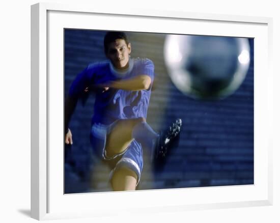 Soccer Player Kicking a Soccer Ball-null-Framed Photographic Print