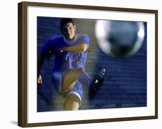 Soccer Player Kicking a Soccer Ball-null-Framed Photographic Print