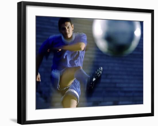 Soccer Player Kicking a Soccer Ball-null-Framed Photographic Print