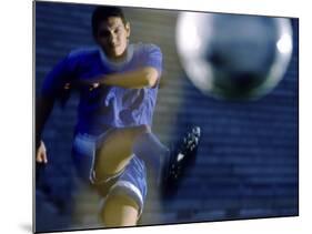 Soccer Player Kicking a Soccer Ball-null-Mounted Photographic Print