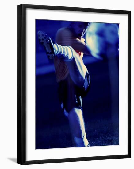 Soccer Player Kicking a Soccer Ball-null-Framed Photographic Print