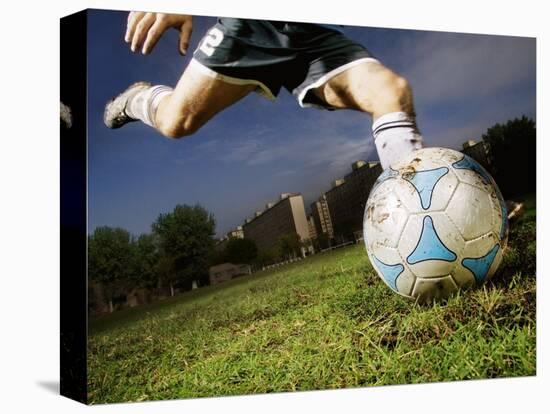 Soccer Player Kicking Ball-Randy Faris-Stretched Canvas