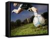 Soccer Player Kicking Ball-Randy Faris-Framed Stretched Canvas