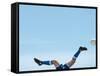 Soccer player upside-down attempting to kick the ball-null-Framed Stretched Canvas