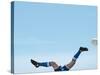 Soccer player upside-down attempting to kick the ball-null-Stretched Canvas