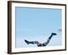 Soccer player upside-down attempting to kick the ball-null-Framed Photographic Print