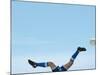 Soccer player upside-down attempting to kick the ball-null-Mounted Photographic Print