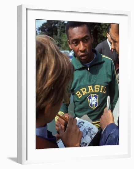 Soccer Star Pele Signing Autographs for Fans During a Practice Prior to World Cup Competition-null-Framed Premium Photographic Print