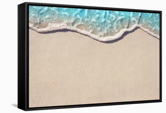 Soft Wave of Blue Ocean on Sandy Beach. Background. Selective Focus.-Lidiya Oleandra-Framed Stretched Canvas