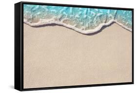 Soft Wave of Blue Ocean on Sandy Beach. Background. Selective Focus.-Lidiya Oleandra-Framed Stretched Canvas