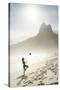 South America, Brazil, Rio de Janeiro, a woman practising football or altinha on Ipanema beach (MR)-Alex Robinson-Stretched Canvas