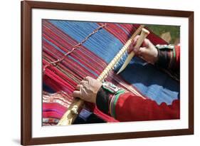 South America, Peru, Chinchero. Chinchero Cooperative weaver demonstrates using loom and tool.-Kymri Wilt-Framed Photographic Print