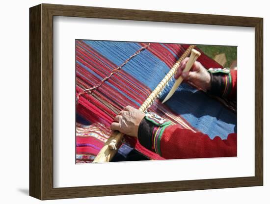 South America, Peru, Chinchero. Chinchero Cooperative weaver demonstrates using loom and tool.-Kymri Wilt-Framed Photographic Print