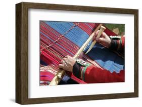 South America, Peru, Chinchero. Chinchero Cooperative weaver demonstrates using loom and tool.-Kymri Wilt-Framed Photographic Print