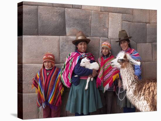 South America, Peru, Cusco. Quechua People in Front of An Inca Wall, Holding a Lamb and a Llama-Alex Robinson-Stretched Canvas