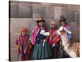 South America, Peru, Cusco. Quechua People in Front of An Inca Wall, Holding a Lamb and a Llama-Alex Robinson-Stretched Canvas