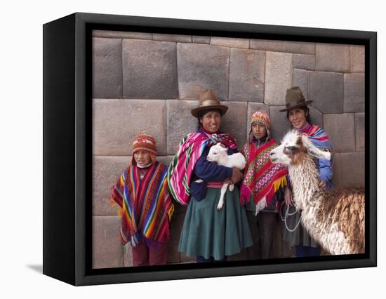 South America, Peru, Cusco. Quechua People in Front of An Inca Wall, Holding a Lamb and a Llama-Alex Robinson-Framed Stretched Canvas