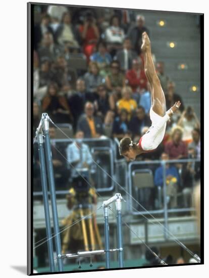 Soviet Gymnast Olga Korbut in Action on the Uneven Bars at the Summer Olympics-John Dominis-Mounted Premium Photographic Print