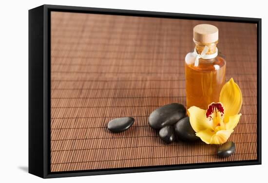 Spa, Health and Beauty Concept - Closeup of Essential Oil, Massage Stones and Orchid Flower-dolgachov-Framed Stretched Canvas