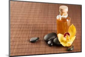 Spa, Health and Beauty Concept - Closeup of Essential Oil, Massage Stones and Orchid Flower-dolgachov-Mounted Photographic Print