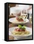 Spaghetti with Tomato Sauce and Glasses of White Wine on Table-null-Framed Stretched Canvas