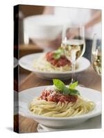 Spaghetti with Tomato Sauce and Glasses of White Wine on Table-null-Stretched Canvas