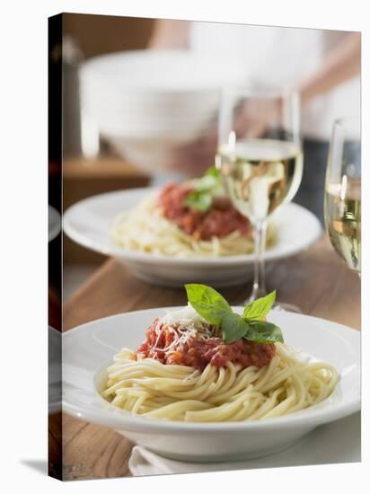 Spaghetti with Tomato Sauce and Glasses of White Wine on Table-null-Stretched Canvas