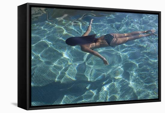 Spain, Ibiza, Cala Jondal. Girl Swimming at Maison De Bang Bang Villa-Katie Garrod-Framed Stretched Canvas