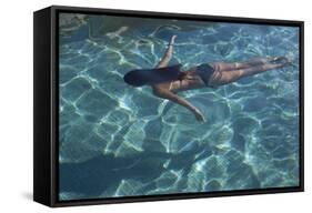 Spain, Ibiza, Cala Jondal. Girl Swimming at Maison De Bang Bang Villa-Katie Garrod-Framed Stretched Canvas