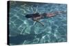 Spain, Ibiza, Cala Jondal. Girl Swimming at Maison De Bang Bang Villa-Katie Garrod-Stretched Canvas