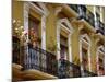 Spain, Sevilla, Andalucia Geraniums hang over iron balconies of traditional houses-Merrill Images-Mounted Photographic Print