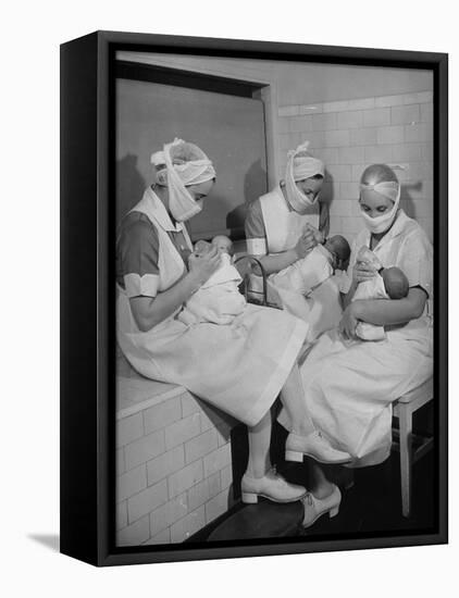 Special Nursery Nurses Wearing Masks as They Bottle-Feed Fully Developed Premature Babies-Hansel Mieth-Framed Stretched Canvas