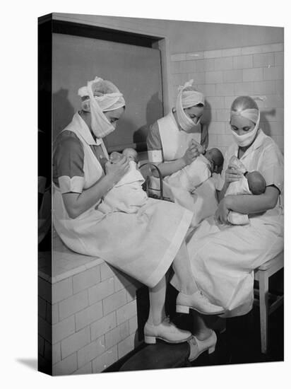 Special Nursery Nurses Wearing Masks as They Bottle-Feed Fully Developed Premature Babies-Hansel Mieth-Stretched Canvas