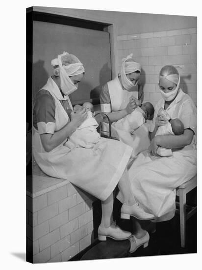 Special Nursery Nurses Wearing Masks as They Bottle-Feed Fully Developed Premature Babies-Hansel Mieth-Stretched Canvas