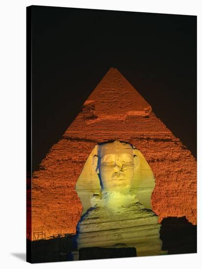 Sphinx and One of the Pyramids Illuminated at Night, Giza, Cairo, Egypt-Nigel Francis-Stretched Canvas