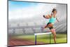 Sportswoman Practising the Hurdles against View of a Stadium-vectorfusionart-Mounted Photographic Print