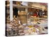 Stall Selling Cheese, Fruit Cake and Sausages at Christmas Market on Maxheinhardtplatz-Richard Nebesky-Stretched Canvas