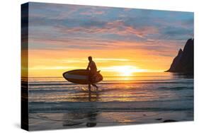 Stand up paddle boarder man admiring midnight sun walking back to the beach-Roberto Moiola-Stretched Canvas